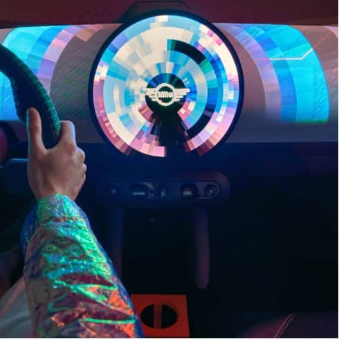 Closeup view of the MINI Concept Aceman’s free-floating central console and round OLED display lit up with animated projections.