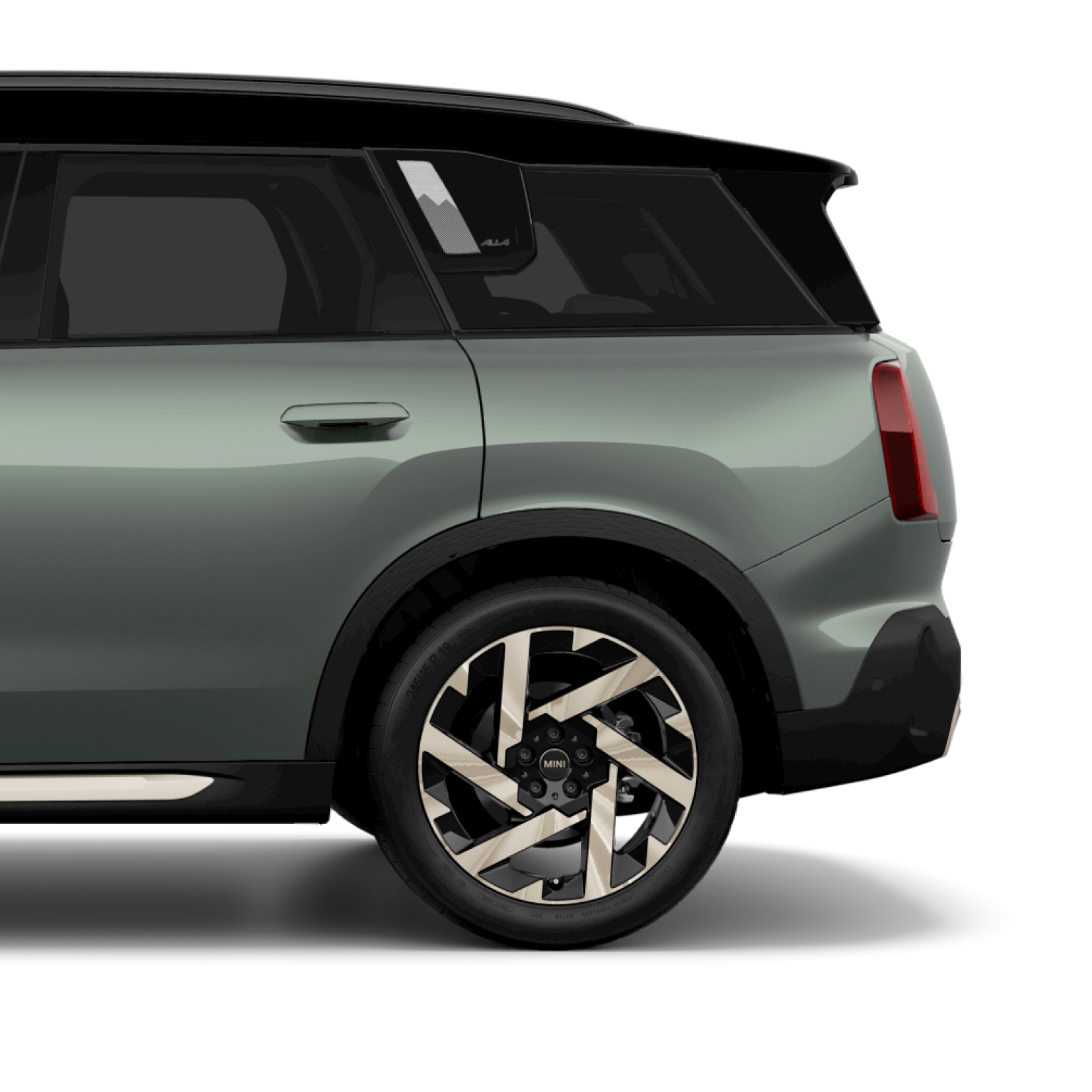Side view of the rear of a 2025 MINI Countryman in Smokey Green, parked on a blank white surface with its shadow underneath it and nothing in the background.