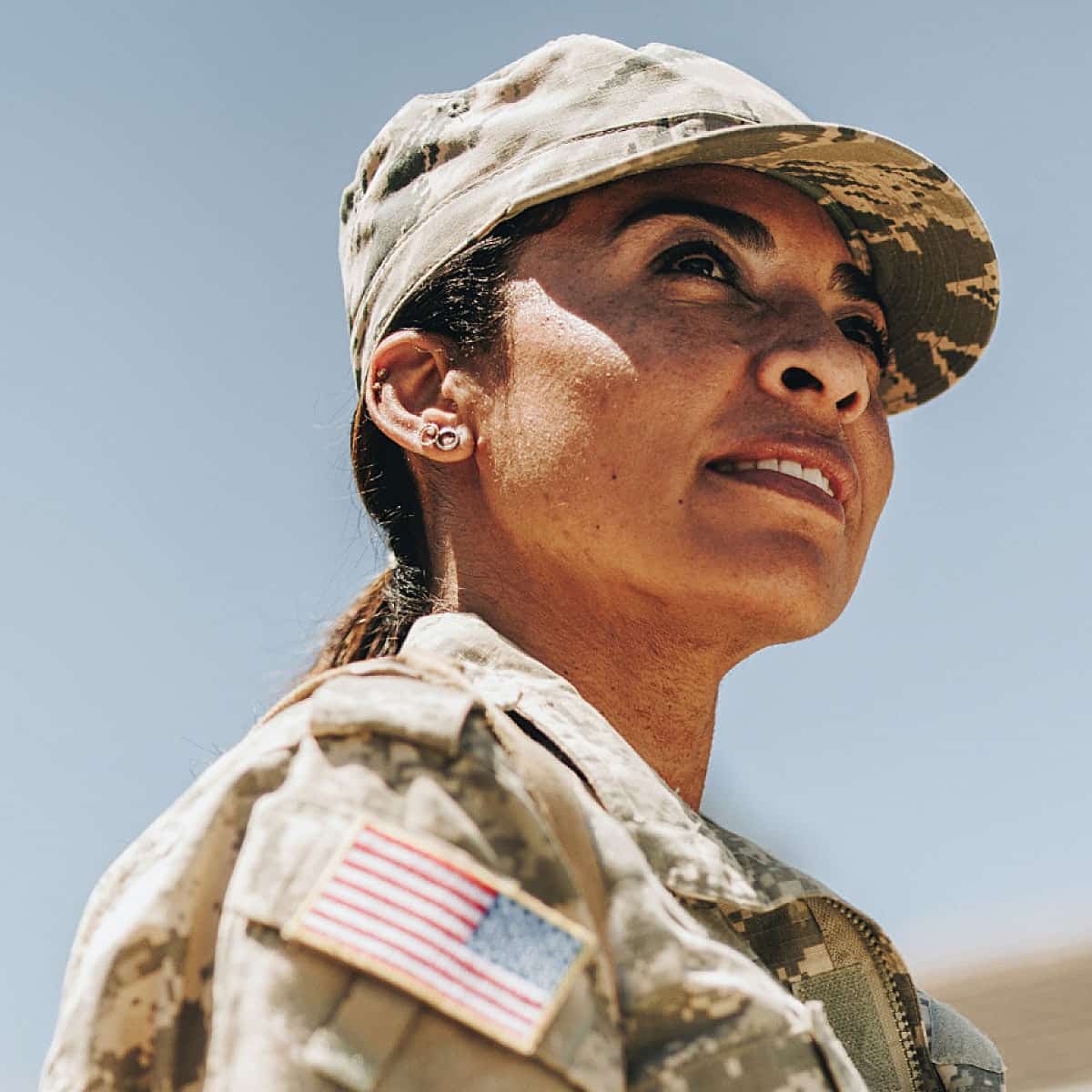 A female military member in a desert landscape