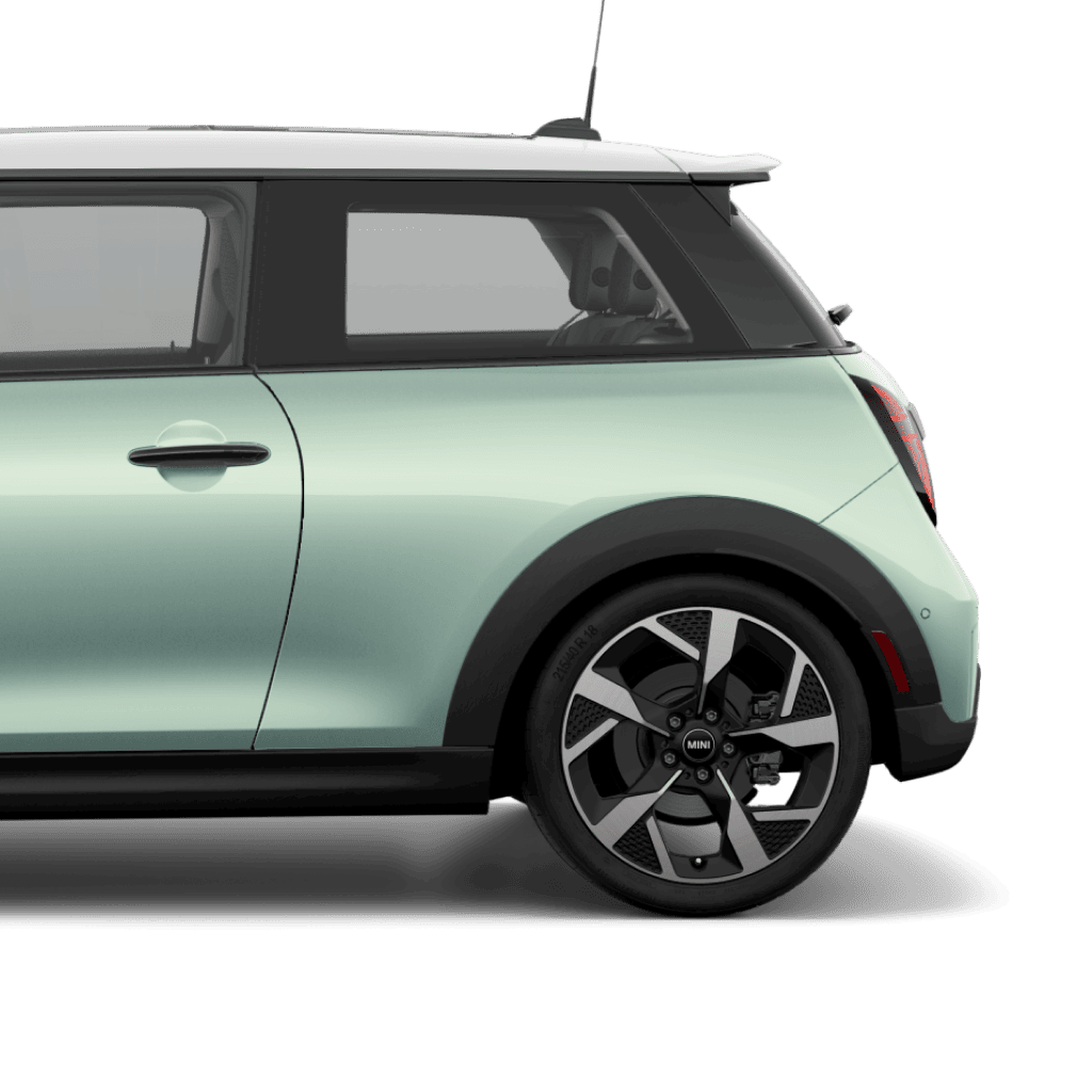 Side view of the rear of a 2025 MINI Cooper S 2 Door in Ocean Wave Green, parked on a blank white surface with its shadow underneath it and nothing in the background.