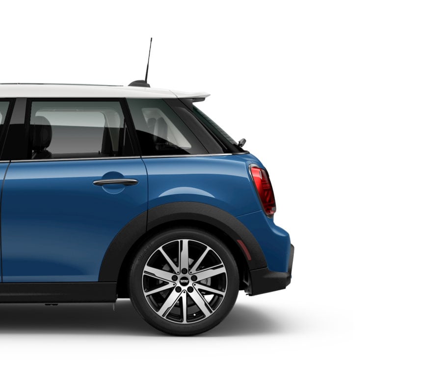 Side view of the rear of a blue MINI Hardtop 4 Door vehicle parked on a blank white surface with its shadow underneath and nothing in the background.